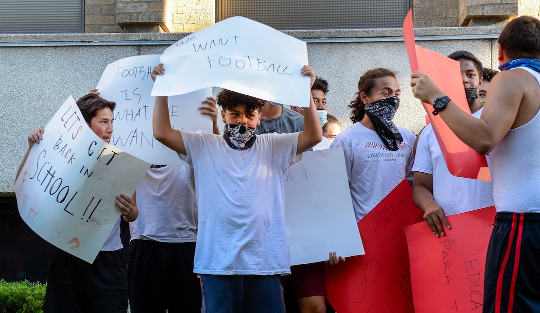 (Leah Hogsten  |  The Salt Lake Tribune) East High School football team players rally in support of team sports Wednesday evening. Parents and students within the Salt Lake City School District rally for K-12 students to return in-person to school this fall, July 15, 2020.
