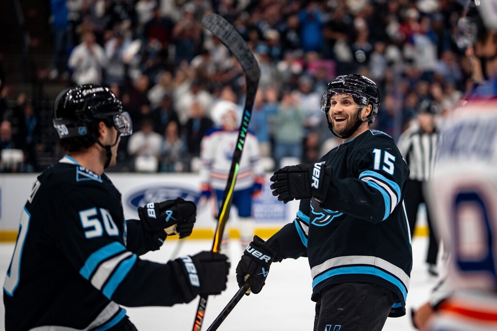 (Trent Nelson | The Salt Lake Tribune) Utah Mammoth center Alexander Kerfoot (15) celebrates his first period goal as the Utah Mammoth host the Edmonton Oilers, NHL hockey in Salt Lake City on Tuesday, March 24, 2026. At left is Utah Mammoth defenseman Sean Durzi (50).