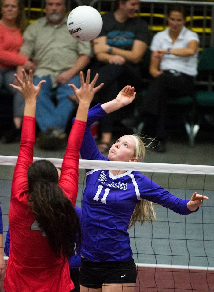 (Rick Egan  |  The Salt Lake Tribune)  Box Elder Bees Emily Isaacson (11) hits the ball, Bountiful Braves Brook Pe’a (4)defends, in 5A volleyball championship game, Bountiful vs. Box Elder, at Utah Valley University, Saturday, November 4, 2017.