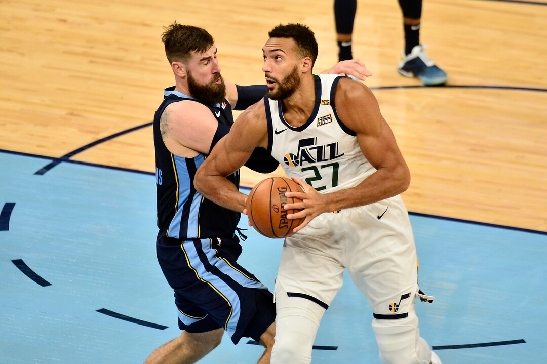Utah Jazz center Rudy Gobert (27) handles the ball against Memphis Grizzlies center Jonas Valanciunas in the second half of Game 4 of an NBA basketball first-round playoff series Monday, May 31, 2021, in Memphis, Tenn. (AP Photo/Brandon Dill)