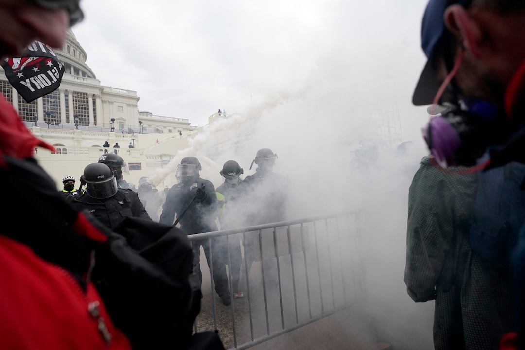 Trump supporters try to break through a police barrier, Wednesday, Jan. 6, 2021, at the Capitol in Washington. As Congress prepares to affirm President-elect Joe Biden's victory, thousands of people have gathered to show their support for President Donald Trump and his claims of election fraud. (AP Photo/Julio Cortez)