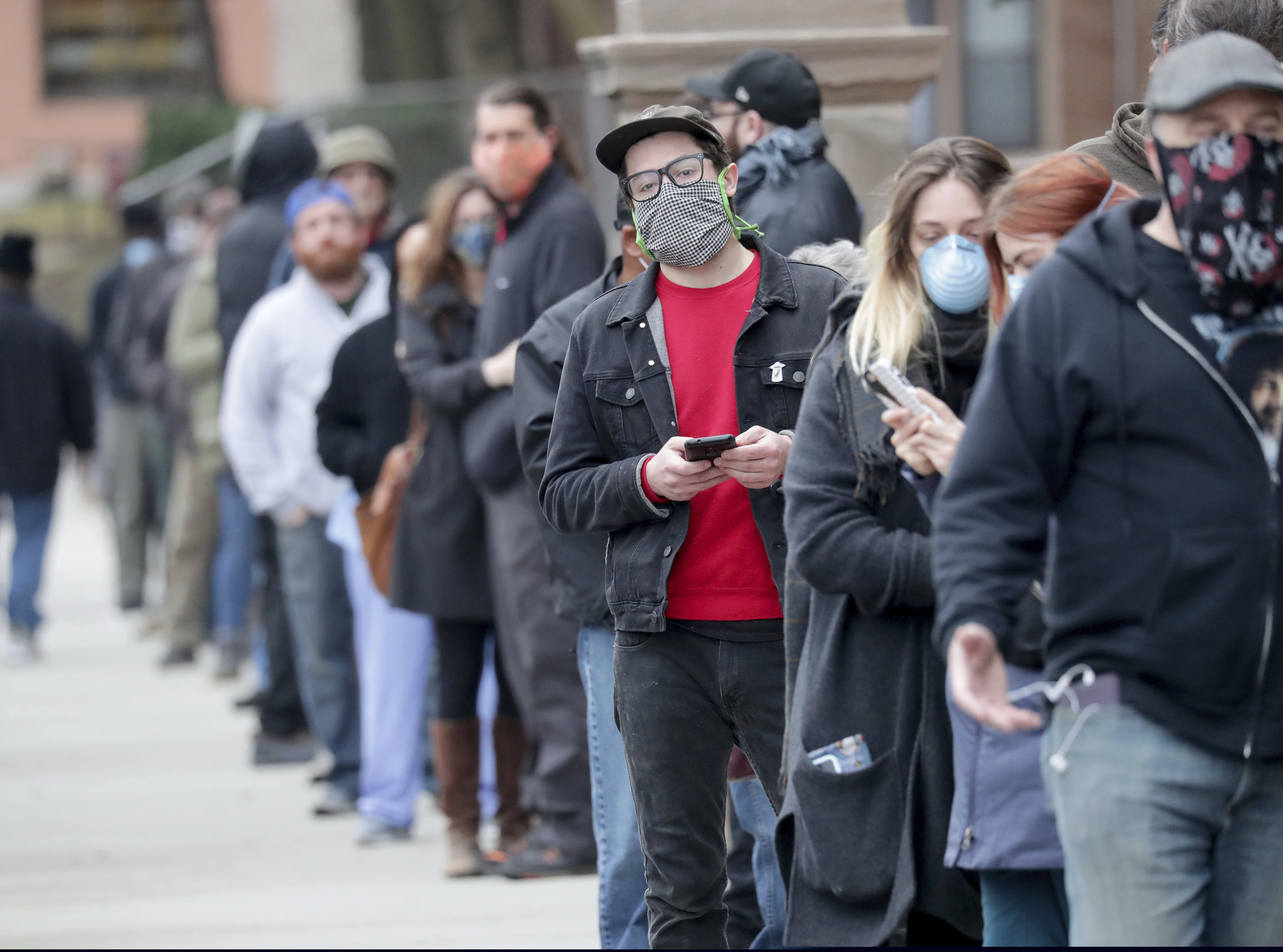 (Mike De Sisti | Milwaukee Journal-Sentinel | AP) People line up to vote at Riverside High School during the primary in Milwaukee on Tuesday, April 7, 2020. Voters lined up to cast ballots across Wisconsin on Tuesday, ignoring a stay-at-home order in the midst of the coronavirus pandemic to participate in the state's presidential primary election.