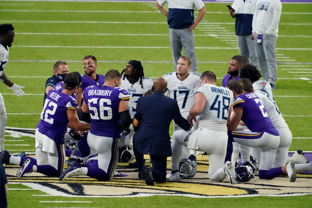 (Jim Mone | AP) Tennessee Titans and the Minnesota Vikings players meet at midfield following an NFL football game, Sunday, Sept. 27, 2020, in Minneapolis. Tennessee won 31-30. The NFL says the Tennessee Titans and Minnesota Vikings are suspending in-person activities after the Titans had three players test positive for the coronavirus, along with five other personnel. The league says both clubs are working closely with the NFL and the players’ union on tracing contacts, more testing and monitoring developments. The Titans are scheduled to host the Pittsburgh Steelers on Sunday.