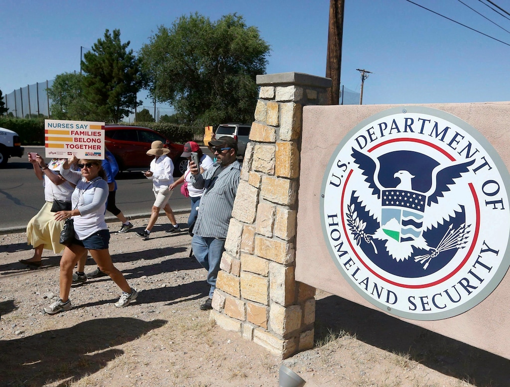 FILE - This June 2018 file photo shows protesters walking along Montana Avenue outside the El Paso Processing Center, in El Paso, Texas. The U.S. government has suddenly stopped force-feeding a group of men on a hunger strike inside a Texas immigration detention center, U.S. Immigration and Customs Enforcement said Thursday, Feb. 14, 2019. The dramatic reversal comes as public pressure was mounting on ICE to halt the practice, which involves feeding detainees through nasal tubes against their will. (Rudy Gutierrez/The El Paso Times via AP, File)