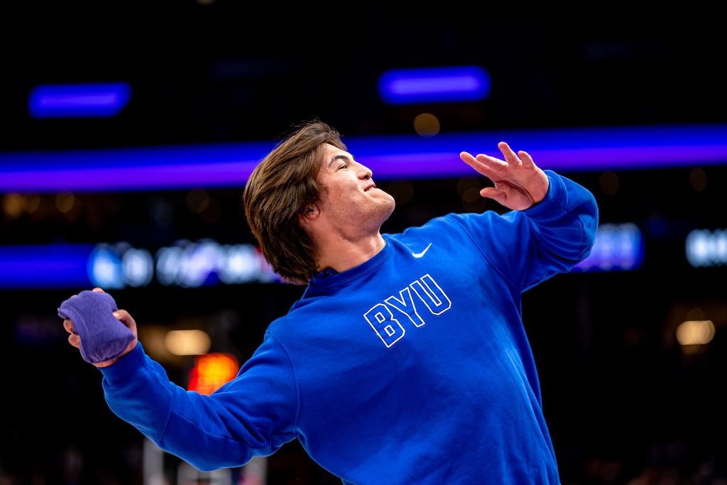 (Trent Nelson  |  The Salt Lake Tribune) BYU quarterback Bear Bachmeier throws items to fans during a Utah Jazz game.