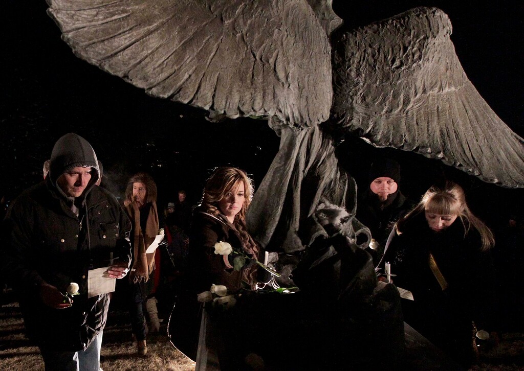 (Leah Hogsten  |  Tribune file photo) Friends and family whose infants and young children have died gather at the Christmas Box Angel statue in the Salt Lake City Cemetery for a candlelight vigil and to lay flowers at the angels feet in remembrance of their loved ones on Dec. 6, 2013. Writer Loren Rhodes features the Christmas Box Angel and the Salt Lake City Cemetery in her new book, "199 Cemeteries to See Before You Die."