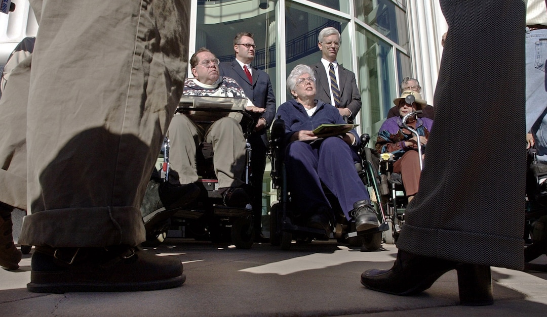 (Steve Griffin  |  Tribune File Photo)  The Disabled Rights Action Committee members, L-R, Ted Loosli, Barbara Toomer, and Doris King, along with their attorneys talk to the media during a  press conference outside the Scott Matheson Courthouse in Salt Lake City on October 17, 2002. The group announced three lawsuits that they are filing against Gateway developers The Boyer Co.