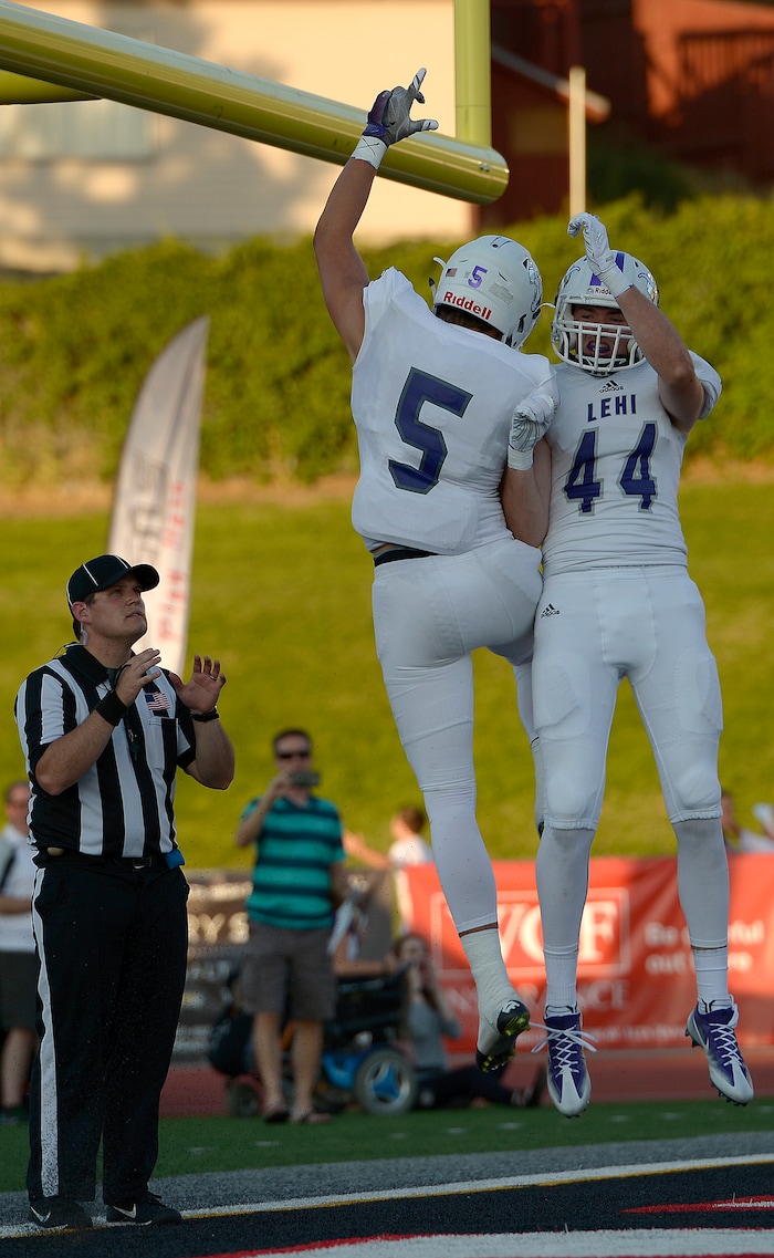 (Leah Hogsten  |  The Salt Lake Tribune) Lehi's Dallin Holker celebrates his touchdown with teammate Kyler Welsh.  Holker caught two touchdown passes. Lehi High School leads Alta High School 42-28 during their game, Friday, August 18, 2017 in Sandy. 