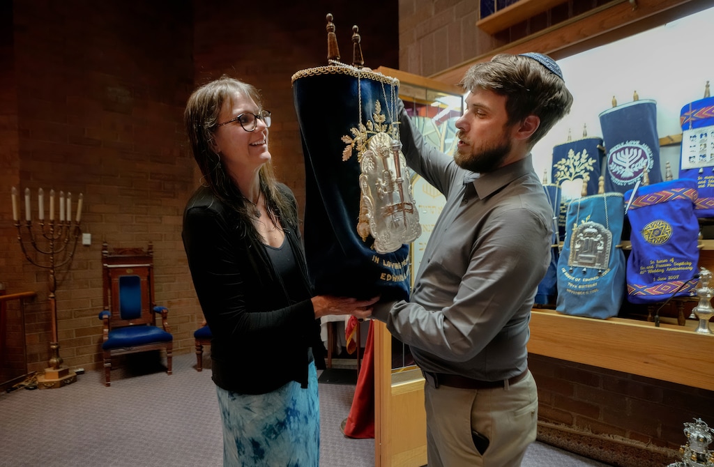 (Francisco Kjolseth | The Salt Lake Tribune) Rabbi Samuel Spector lets Deborah Rumi hold a Torah scroll in a final step of her conversion at Congregation Kol Ami in Salt Lake City.