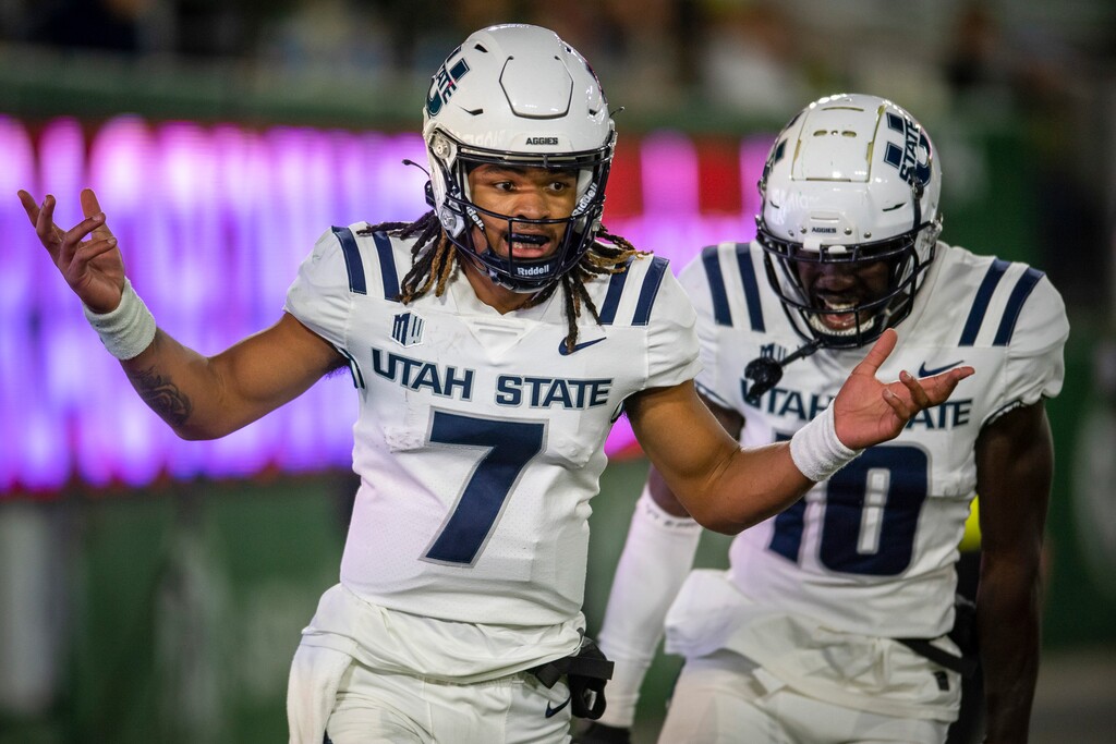 Utah State quarterback Bishop Davenport reacts after scoring a touchdown against Colorado State during the third quarter of an NCAA college football game in Fort Collins, Colo., Saturday, Oct. 15, 2022. (Jon Austria/The Coloradoan via AP)