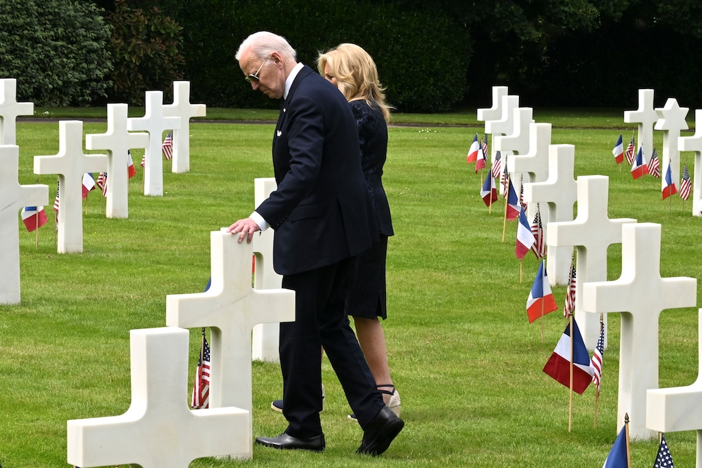 (Kenny Holston | The New York Times) President Joe Biden and first lady Jill Biden walk among the headstones at Normandy American Cemetery in Colleville-sur-Mer, France on the 80th anniversary of D-Day, Thursday, June 6, 2024.
