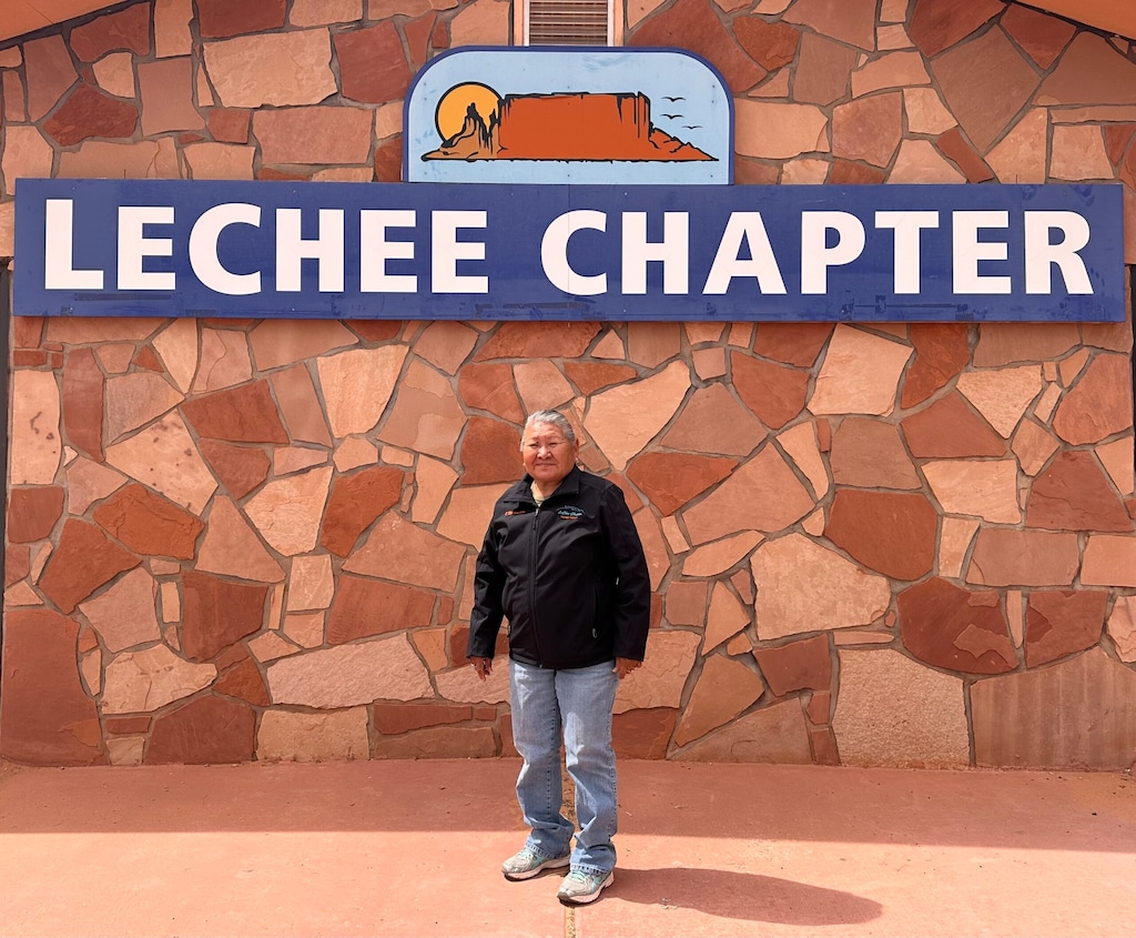 (Beth Henshaw | Corner Post) Irene Whitekiller, LeChee Chapter President, standing in front of the LeChee Chapter House. The LeChee Chapter of the Navajo Nation voted unanimously in February to pass a resolution opposing the City of Page’s decision last year to sell 500 acres of recreational land for a $10 billion data center development. The proposed development site borders the LeChee Chapter, a home to the internationally popular tourist destination of Antelope Canyon.