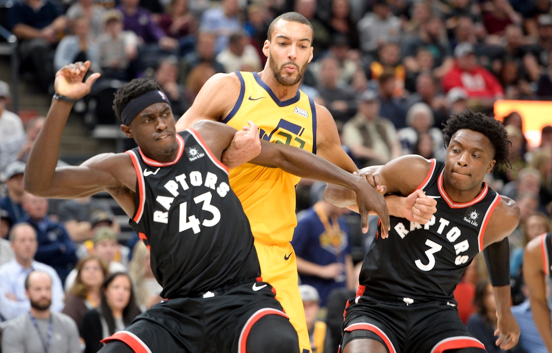 Leah Hogsten  |  The Salt Lake Tribune Toronto Raptors forward Pascal Siakam (43) and Toronto Raptors forward OG Anunoby (3) guard Utah Jazz center Rudy Gobert (27) under the net as the Utah Jazz host the Toronto Raptors, Monday, Nov. 5, 2018 at Vivint Smart Home Arena.