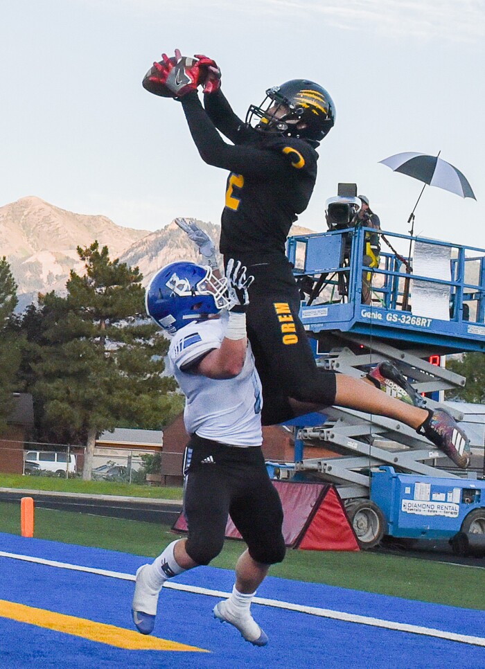 (Francisco Kjolseth  |  The Salt Lake Tribune)  Orem's Puka Nacua pulls in a touchdown pass over Braedon Wissler of Bingham in the first half of the game in Orem, Thursday, Aug. 16, 2018.