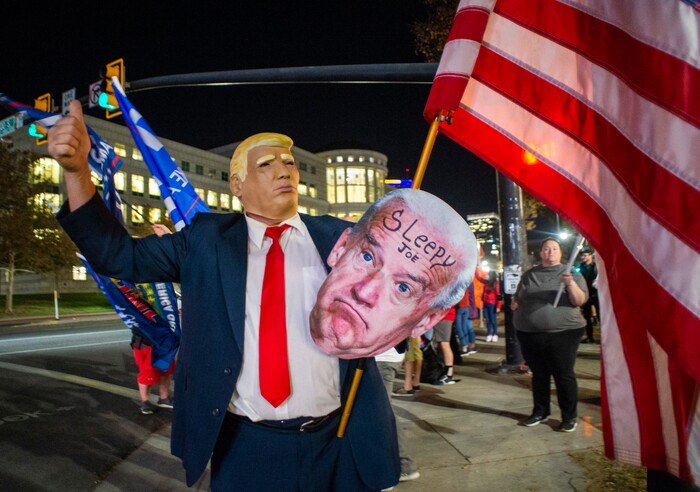(Rick Egan | The Salt Lake Tribune) Trump supporters wave flags during a Trump rally at Washington Square, on Monday, Nov. 2, 2020.