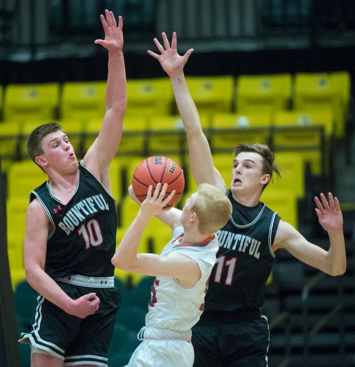 (Rick Egan  |  The Salt Lake Tribune)   Bountiful Braves Brig Willard (10) and  Braves Garrett Buchanan (11)  keep Skyridge Falcons Braden Allfrey (15) from getting a shot off in the final seconds of the game, in 5A basketball playoff action between the Bountiful Braves and Skyridge Falcons, at the UCCU Center in Orem, Monday, Feb. 26, 2018.