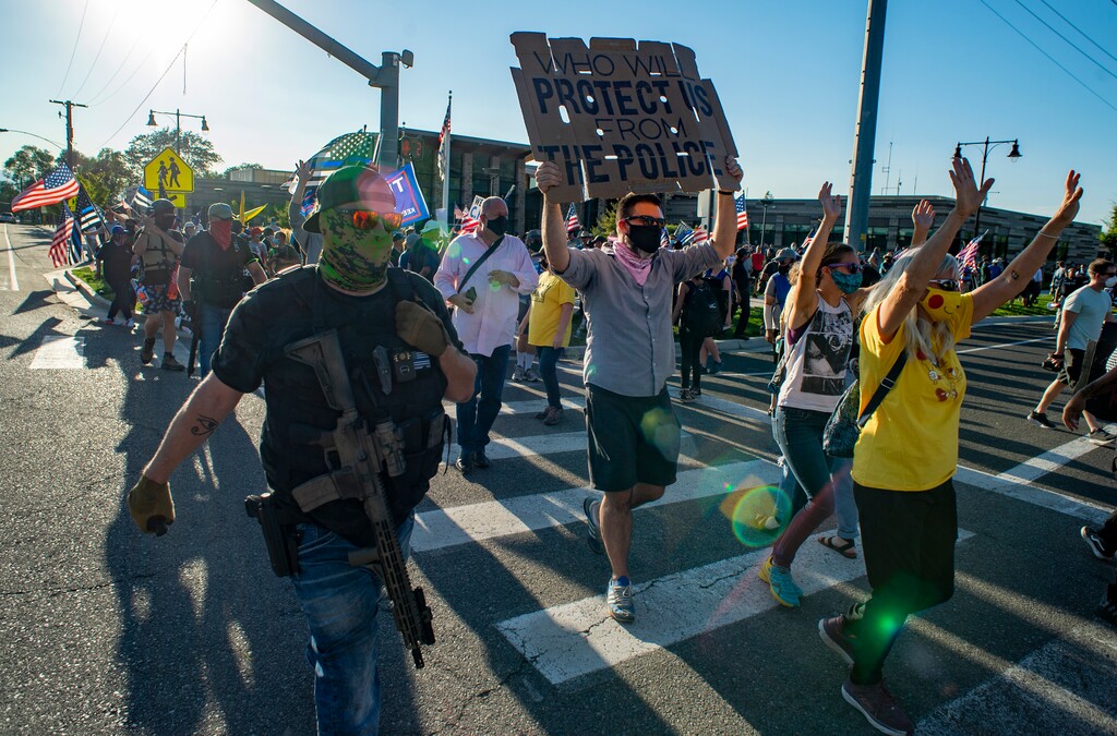 (Rick Egan  |  Tribune file photo)  Protesters chant "Hands up don't shoot" as they walk past the counter protesters at Cottonwood Heights police station on Monday, Aug. 3, 2020.