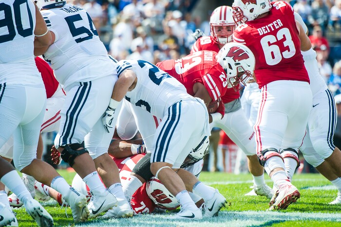 (Chris Detrick  |  The Salt Lake Tribune)   Wisconsin Badgers running back Jonathan Taylor (23) scores a touchdown past Brigham Young Cougars defensive back Tanner Jacobson (25) during the game at LaVell Edwards Stadium Saturday Saturday, September 16, 2017. Wisconsin Badgers are leading Brigham Young Cougars 24-6 at halftime.
