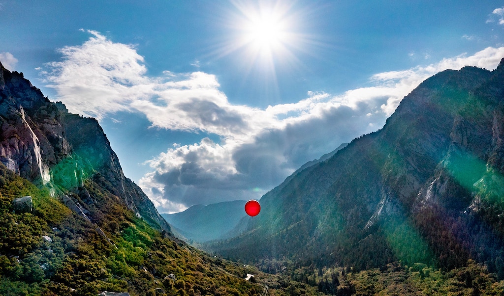 (Francisco Kjolseth | The Salt Lake Tribune) Environmental activists fly large balloons over the mouth of Little Cottonwood Canyon on Saturday, Aug. 21, 2021, to demonstrate the height of gondola towers the Utah Department of Transportation is proposing be built to carry people up to Alta and Snowbird ski resorts.