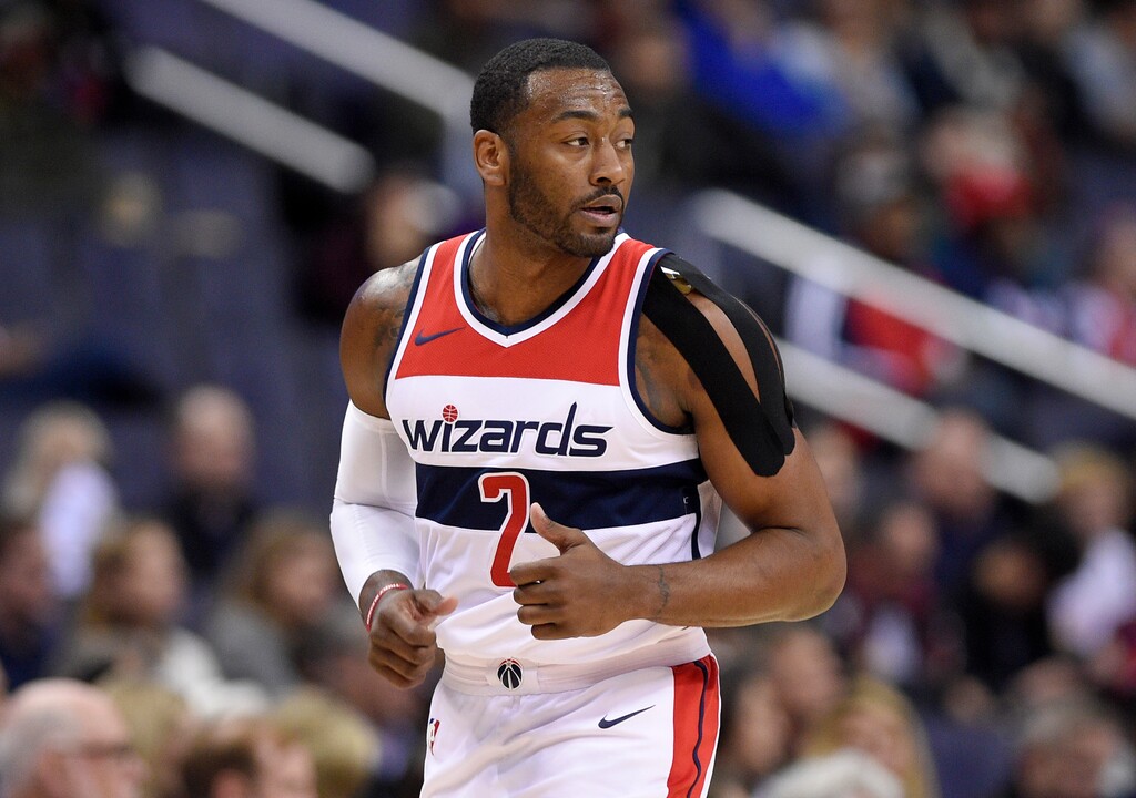 Washington Wizards guard John Wall (2) runs down the court with a heavily taped shoulder during the first half of an NBA basketball game against the Dallas Mavericks, Tuesday, Nov. 7, 2017, in Washington. (AP Photo/Nick Wass)
