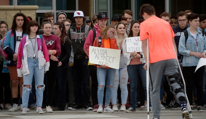 (Al Hartmann  |  The Salt Lake Tribune) 	
About 80 students at Westlake High School in Saratoga Springs left class and stood together in silence at the front entrance of the school Wednesday March 14, 2018 to remember the 17 students who died in a school shooting in Florida.  Westlake senior and event organizer Kaylee Anderson (center) and others held posters of the names of those killed.