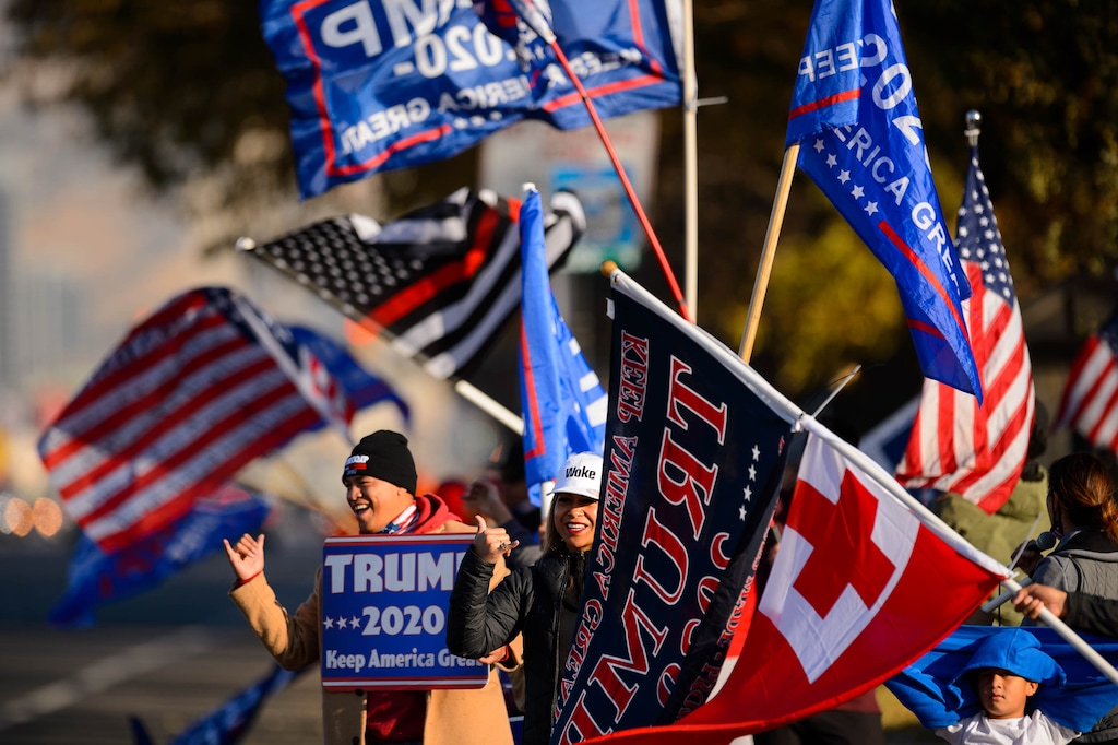 (Trent Nelson  |  Tribune file photo) A group of Trump supporters wave flags on the corner of 2100 S State Street in Salt Lake City on Tuesday, Nov. 3, 2020.