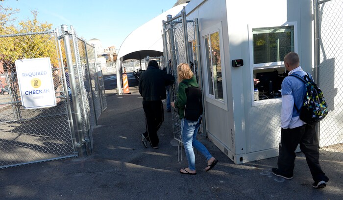 (Al Hartmann | The Salt Lake Tribune)
Starting Friday Oct. 27 homeless check in at booth at right to have their coordinated services card scanned before passing into the "safe space" courtyard outside the Road Home shelter. The area is accessible from the south on Rio Grand Street. The area to the north at 200 South and Rio Grand is fenced and locked.