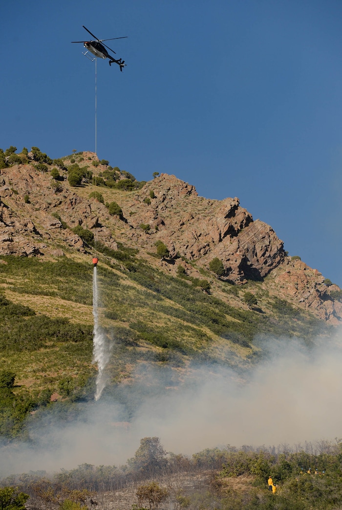 (Francisco Kjolseth  |  The Salt Lake Tribune) Fire crews battle a fire near Millcreek Canyon, on Saturday, July 11, 2020, started near 3400 South Crestwood Dr., as helicopters, single engine air tankers and multiple crews respond.