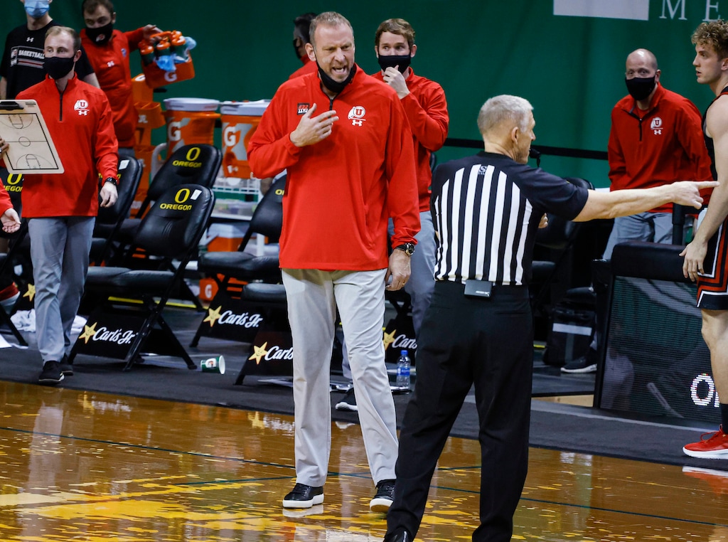 Utah coach Larry Krystkowiak questions an official about a call during the team's NCAA college basketball game against Oregon in Eugene, Ore., Saturday, Feb. 20, 2021. (AP Photo/Thomas Boyd)