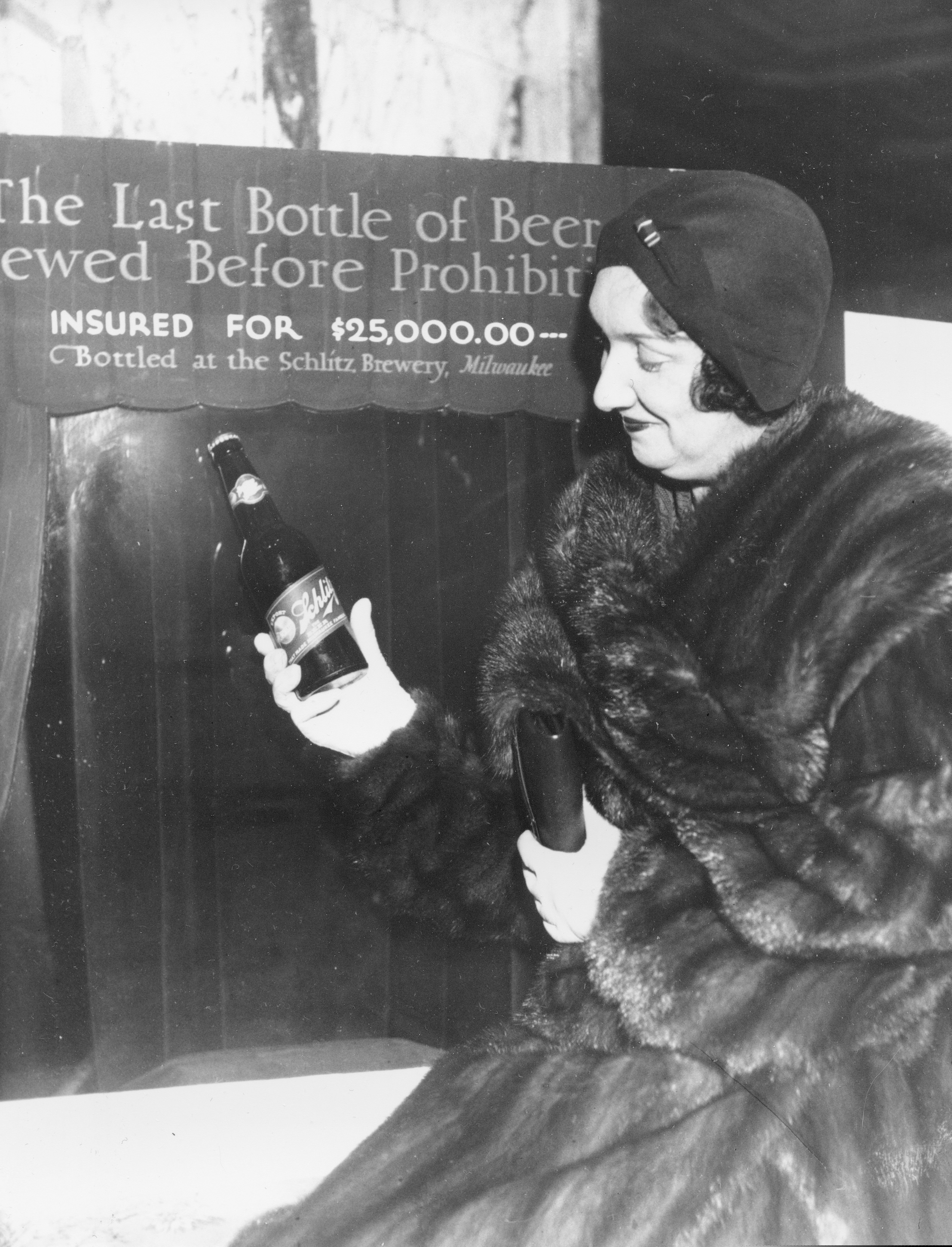FILE - In this Dec. 29, 1930, file photo Rae Samuels holds the last bottle of beer that was distilled before prohibition went into effect in Chicago. The bottle of Schlitz has been insured for $25,000. (AP Photo, File)