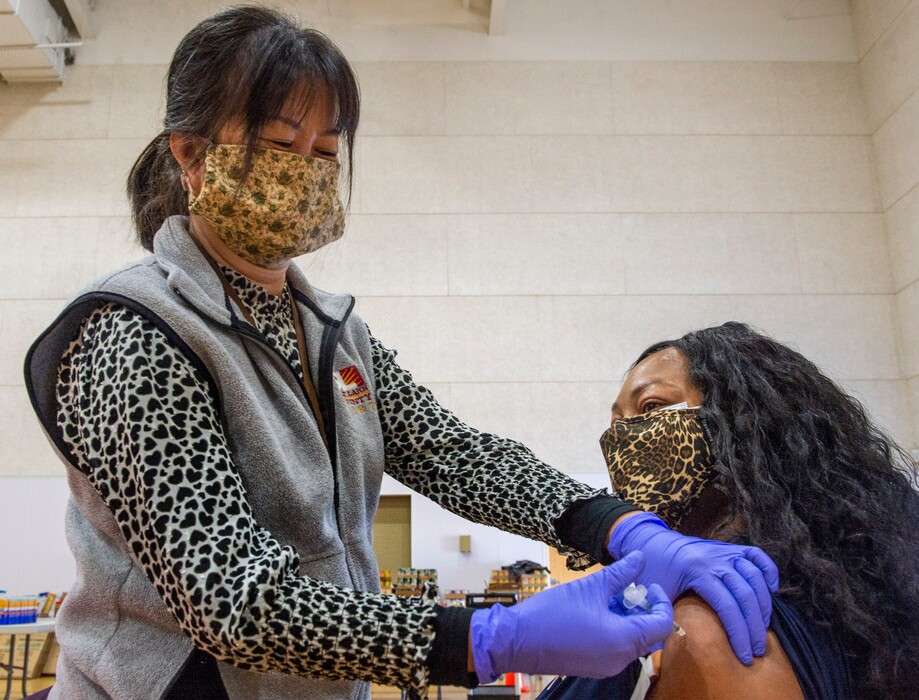 (Rick Egan | The Salt Lake Tribune)  Yen Hguyen adminsiters a Covid 19 Lakeysha Mapps, at the Calvary Baptist Church in Salt Lake City, on Monday, March 1, 2021.