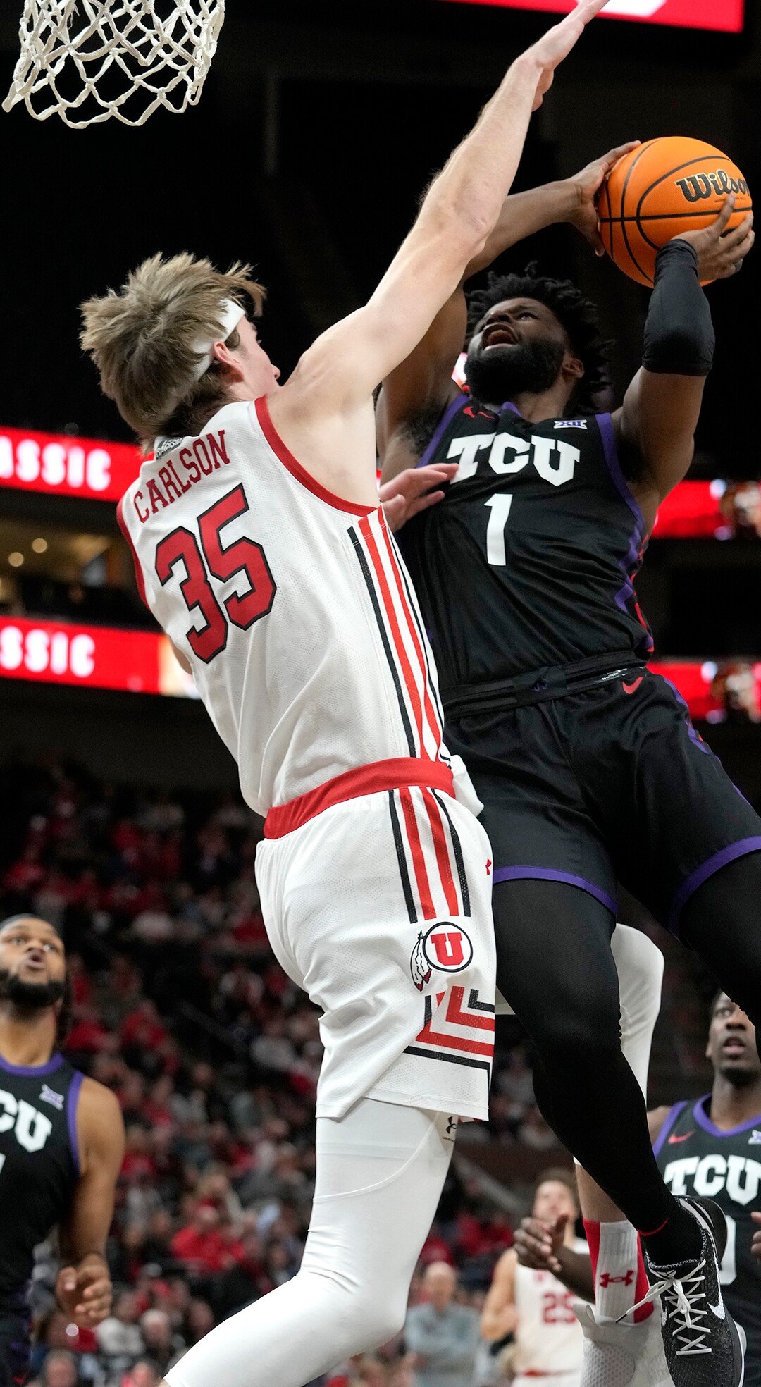 (Leah Hogsten | The Salt Lake Tribune) Utah Utes center Branden Carlson (35) with the block on TCU Horned Frogs guard Mike Miles Jr. (1) as the University of Utah hosts the TCU Horned Frogs at Vivint Arena, Dec. 21, 2022. 