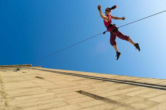 (Photo courtesy of Basil Tsimoyianis) Oakland, Calif.-based “vertical dance” company BANDALOOP performs during Cal Day in Berkeley, Calif. BANDALOOP will be appearing at the Utah Arts Festival June 21-24, and will perform twice daily (5:30 and 7 p.m.) on the six-story library glass wall above the reflecting pool.
