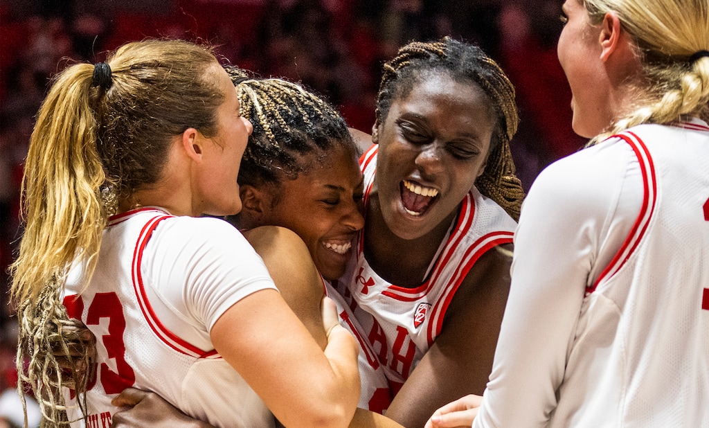 (Rick Egan | The Salt Lake Tribune)  Utah Utes guard Matyson Wilke (23) and center Nene Sow (25) hug Utah forward Dasia Young (34) as the Utes celebrate Young's game-winning shot giving the Utah a  77-76 win over the Colorado Buffaloes, in basketball action at the Jon M. Huntsman Center, on Friday, Feb. 16, 2024.