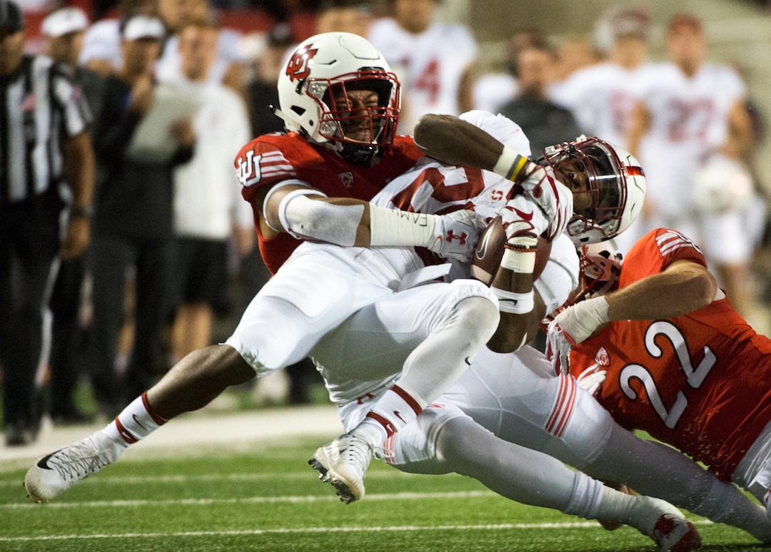 (Rick Egan  |  The Salt Lake Tribune)  Utah Utes linebacker Kavika Luafatasaga (5) and Utah Utes defensive back Chase Hansen (22), bring down Stanford Cardinal running back Bryce Love (20) in PAC-12 football action, Utah Utes vs. Stanford Cardinals, at Rice-Eccles Stadium, Saturday, October 7, 2017.