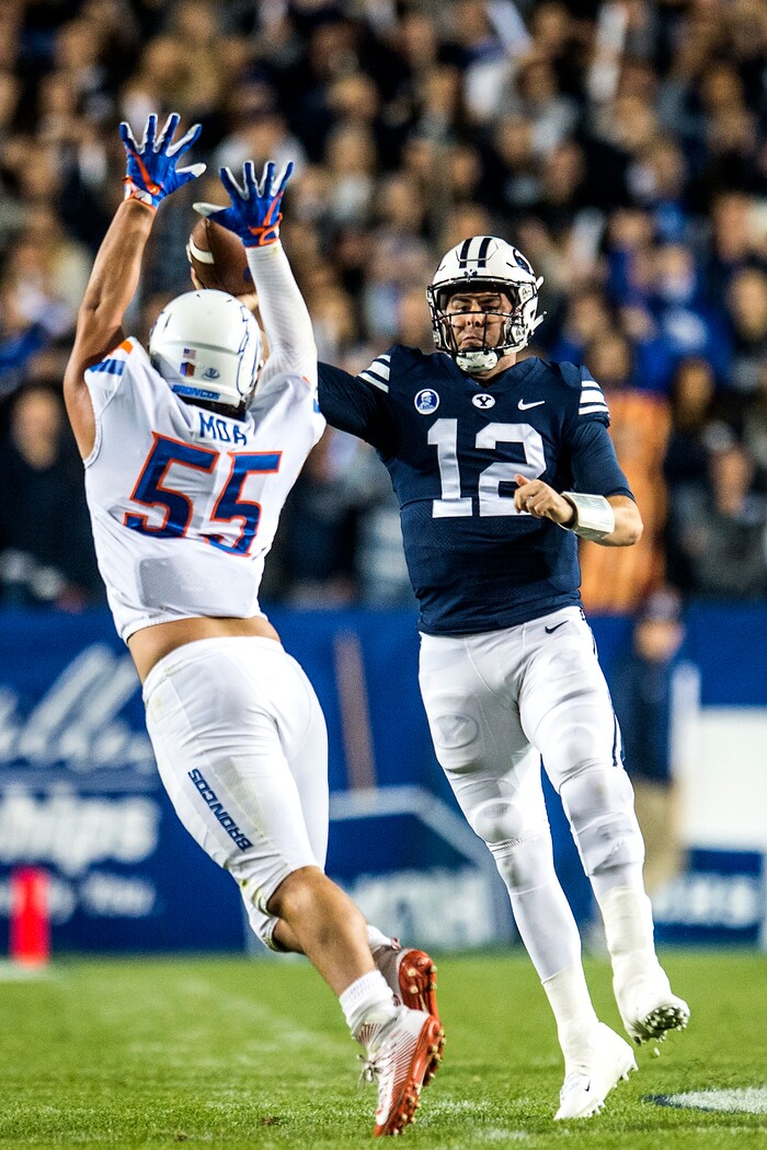(Chris Detrick  |  The Salt Lake Tribune)  Boise State Broncos defensive tackle David Moa (55) puts pressure on Brigham Young Cougars quarterback Tanner Mangum (12)  during the game LaVell Edwards Stadium Friday, October 6, 2017. 