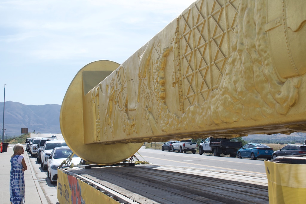 (Clarissa Casper | The Salt Lake Tribune) An attendee views the 43-foot Golden Spike Monument sculpture during a preview event at the future site of Golden Spike State Monument in Brigham City on Thursday, June 26, 2025.