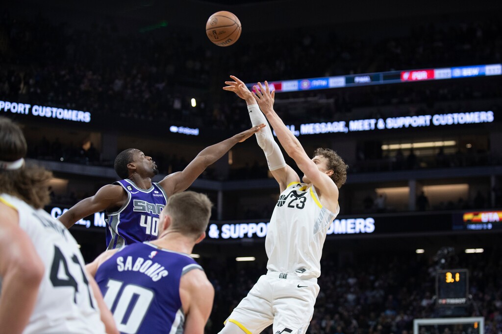 Utah Jazz forward Lauri Markkanen (23) shoots but misses as Sacramento Kings forward Harrison Barnes (40) defends in the closing seconds on an NBA basketball game in Sacramento, Calif., Friday, Dec. 30, 2022. The Kings won 126-125. (AP Photo/José Luis Villegas)