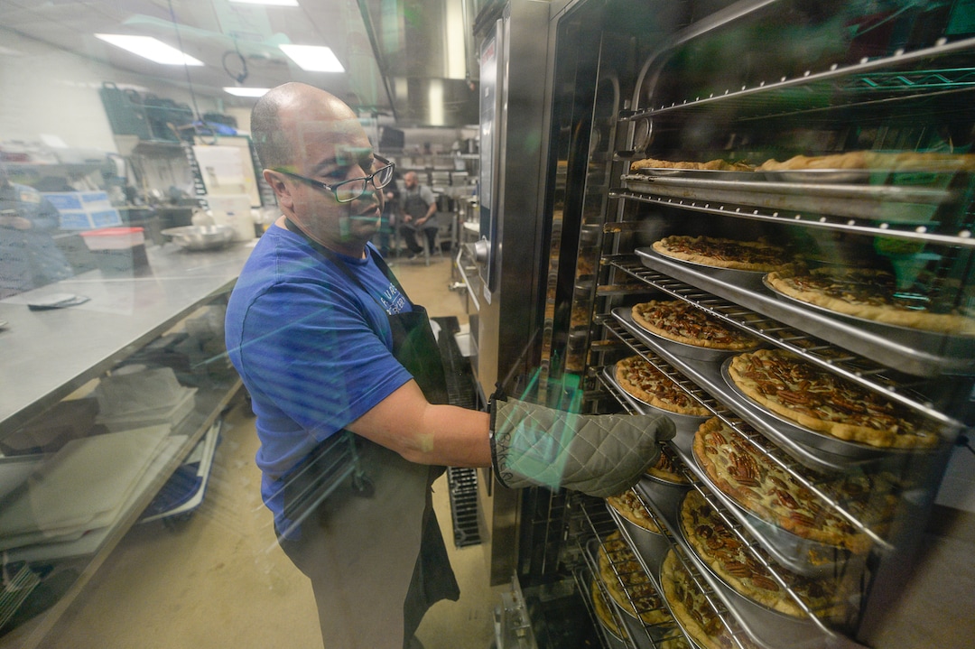 (Francisco Kjolseth  |  The Salt Lake Tribune)  Dennis Sisneros, an intern at Flourish Bakery checks on a large order of pecan pies during a rush to fulfill a large order before the Thanksgiving holiday on Tuesday, Nov. 26, 2019. Flourish Bakery needs to find a new home before Christmas. The non-profit bakery teaches those who have been incarcerated or recovering from substance abuse the art of baking. The skills they learn help them get a job and become financially independent. The bakery has been housed at SLCC's South City campus, but the college has said they can no longer use the space.