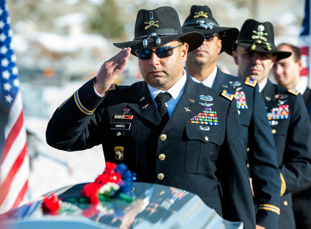 (Rick Egan  |  The Salt Lake Tribune)   Helicopter pilot, Jared Morris, salutes Kirk T. Fuchigami Jr's casket after the funeral in Brigham City. Morris trained with Fuchigami Jr, before he left for Afghanistan. Monday, Dec. 9, 2019.