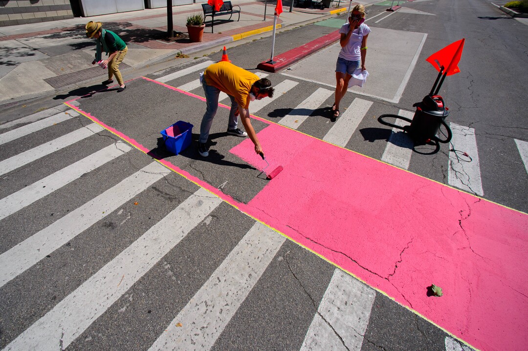 (Trent Nelson  |  The Salt Lake Tribune)  Jann Haworth's Rose art project is painted on Broadway in Salt Lake City on Sunday Aug. 11, 2019. From left, Haworth, Tyler Bloomquist, and Lauren Brown.
