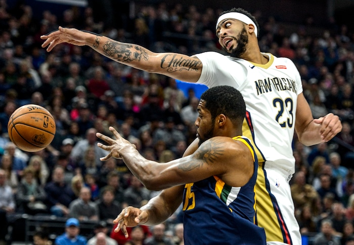 (Steve Griffin  |  The Salt Lake Tribune) New Orleans Pelicans forward Anthony Davis (23) stretches as he tries to block a pass by Utah Jazz forward Derrick Favors (15) during the the Utah Jazz versus the New Orleans Pelicans NBA basketball game at the Vivint Smart Home Arena in Salt Lake City Wednesday January 3, 2018.