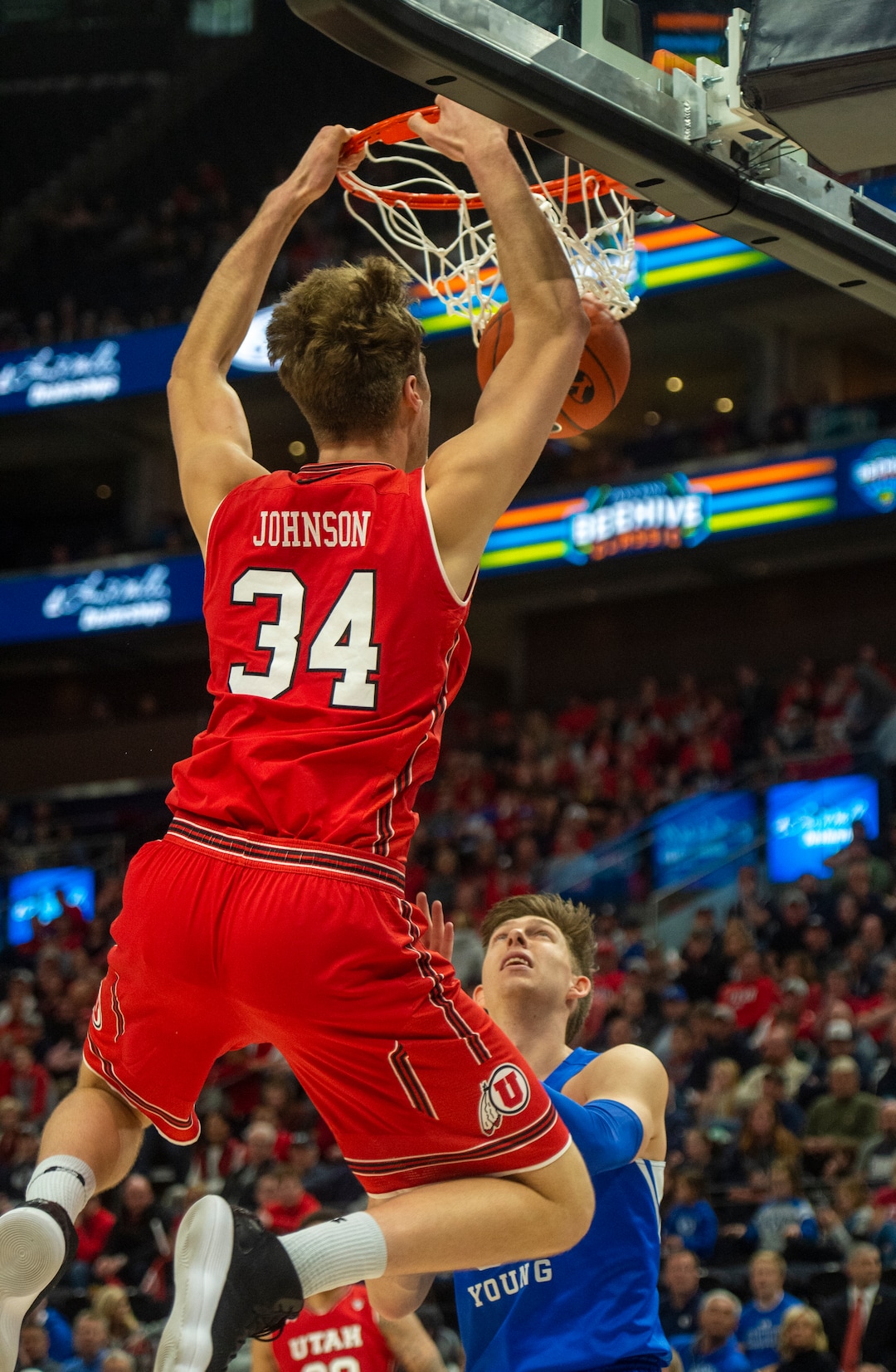 (Rick Egan  |  The Salt Lake Tribune)   Utah Utes center Jayce Johnson (34) dunks the ball and takes out against the Brigham Young Cougars forward Dayton Nixon (33) on the play in basketball action in the Beehive Classic, between against the Brigham Young Cougars and Utah Utes, a the Vivint Smart Home Arena, Saturday December 8, 2018.