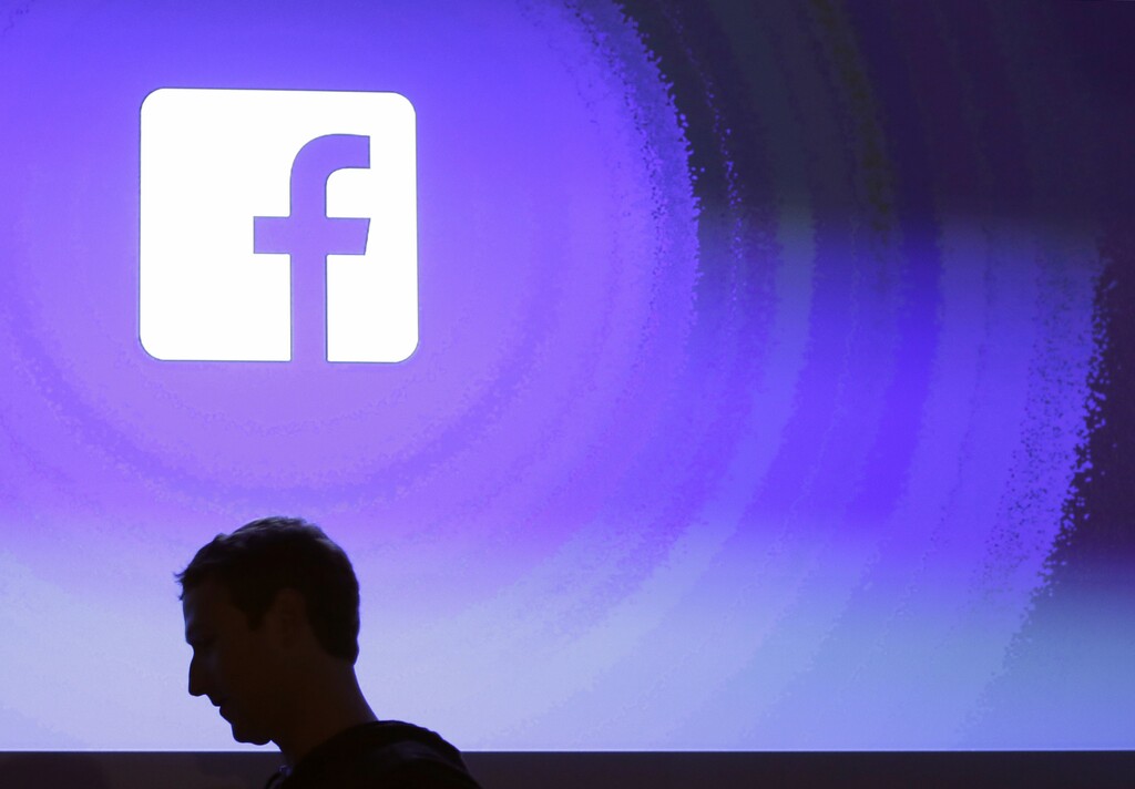 (AP Photo/Marcio Jose Sanchez, File) In this April 4, 2013, file photo, Facebook CEO Mark Zuckerberg walks at the company's headquarters in Menlo Park, Calif. Facebook is having one of its worst weeks as a publicly traded company with a share sell-off continuing for a second day. Britain's Commissioner Elizabeth Denham told the BBC that she was investigating Facebook and has asked the company not to pursue its own audit of Cambridge Analytica's data use. Denham is also pursuing a warrant to search Cambridge Analytica's servers.