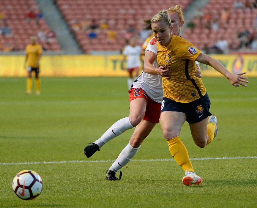 (Francisco Kjolseth | The Salt Lake Tribune) Utah Royals FC hosts Washington Spirit, NWSL soccer at Rio Tinto Stadium in Sandy, Wed. Aug. 8, 2018. Utah Royals FC forward Amy Rodriguez (8) tries to get past Washington Spirit midfielder Tori Huster (23), losing part of her shoe, during the first half of the game.