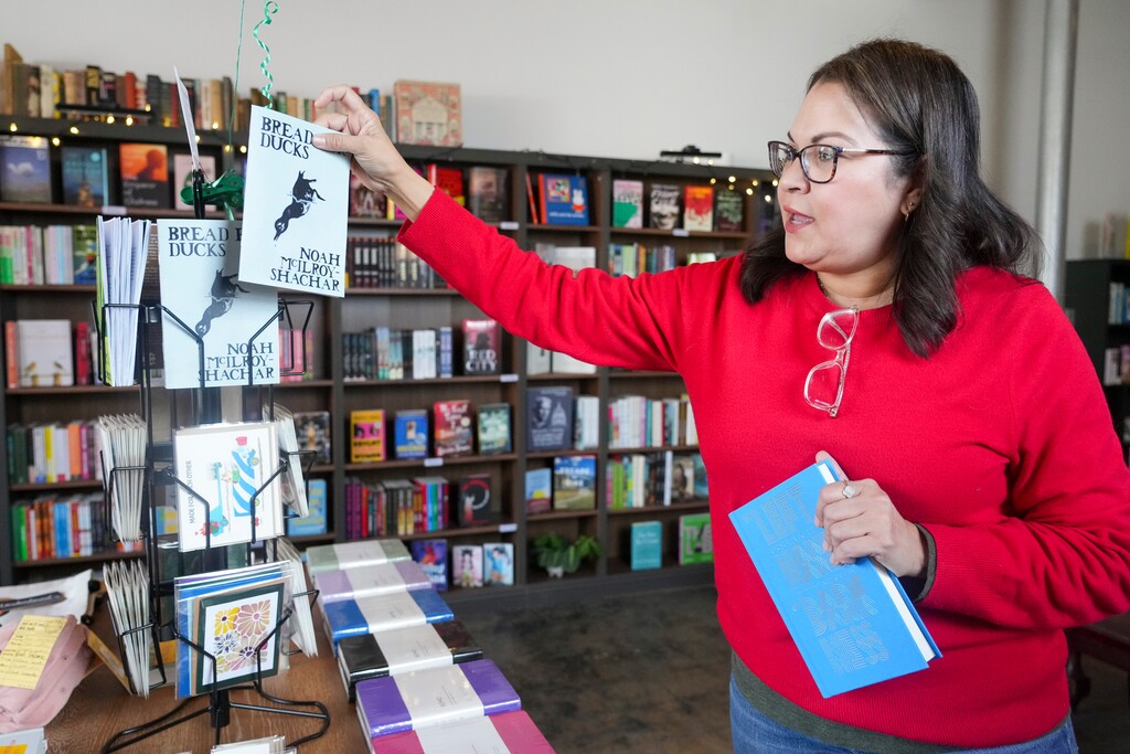 (Bethany Baker| The Salt Lake Tribune) Owner Annie Pagett picks out a booklet of poetry for sale in her store 1974 Bookstore SLC in Salt Lake City on Tuesday, Feb. 3, 2026.