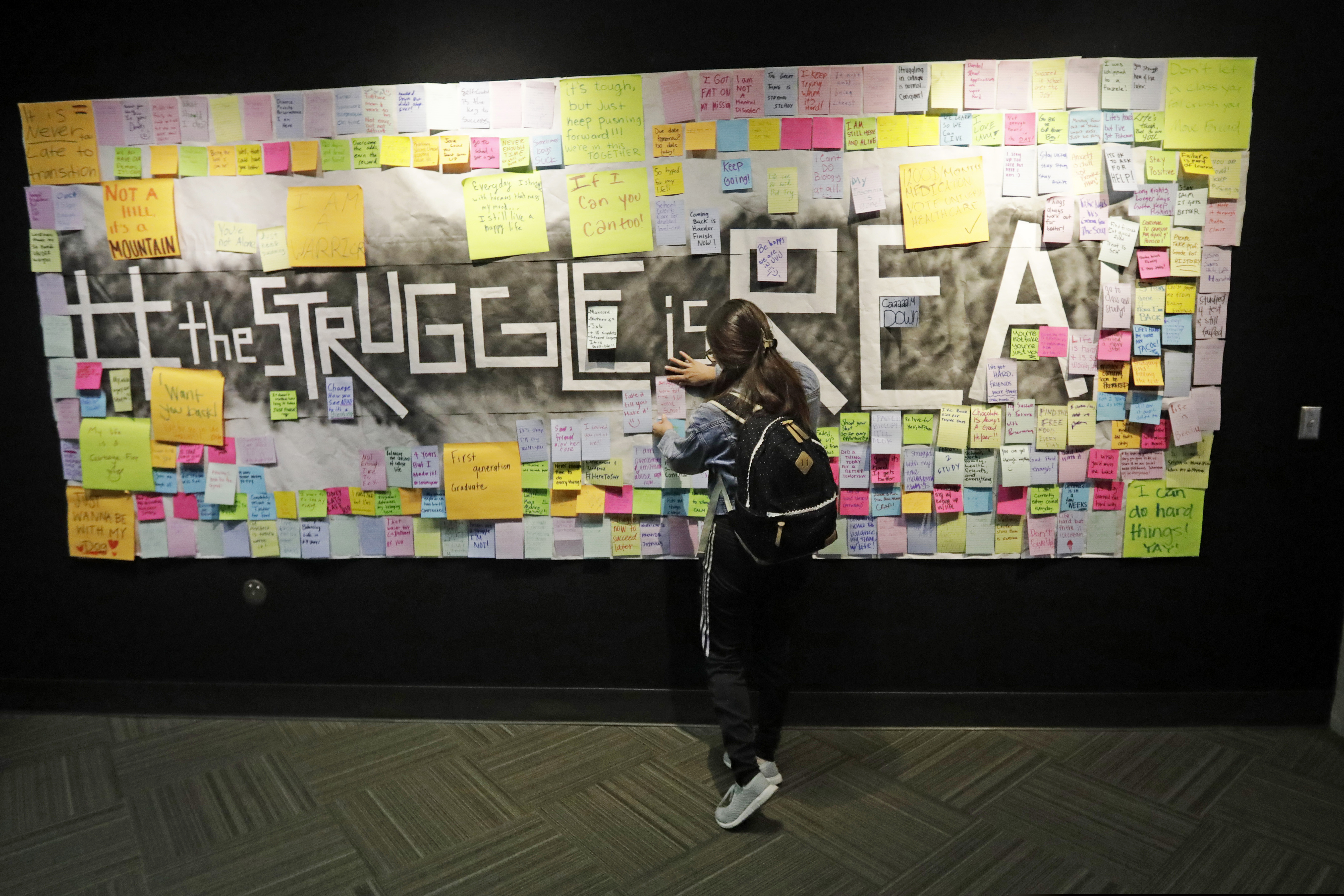(Rick Bowmer | AP file photo)
In this Nov. 14, 2019, photo, a student attaches a note to the Resilience Project board on the campus of Utah Valley University, in Orem, Utah. The purpose of the project is to let students know that it is OK to struggle. More college students are turning to their schools for help with anxiety, depression and other mental health problems. That's according to an Associated Press review of more than three dozen public universities.