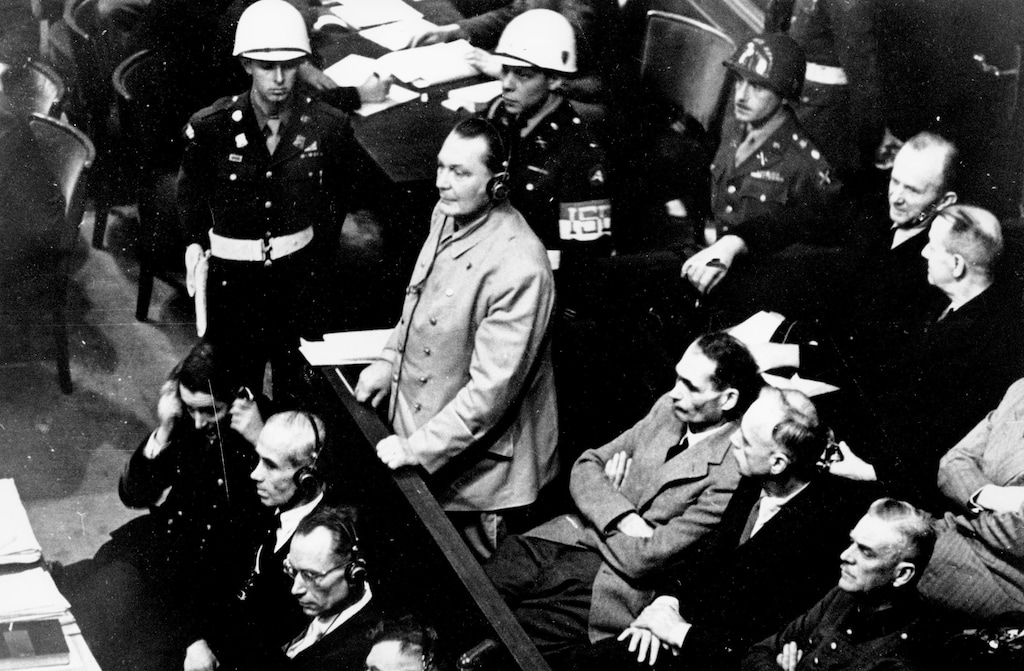 (AP) In this Nov. 21, 1945 file photo, Reichsmarshal Hermann Goering stands in the prisoner's dock at the Nuremberg War Crimes Trial in Germany. He is entering a plea of not guilty to the International Military Tribunal Indictment. Goering is wearing headphones of the court translating system. Germany marks the 75th anniversary of the landmark Nuremberg trials of several Nazi leaders and in what is now seen as the birthplace of a new era of international law on Friday, Nov. 20, 2020.