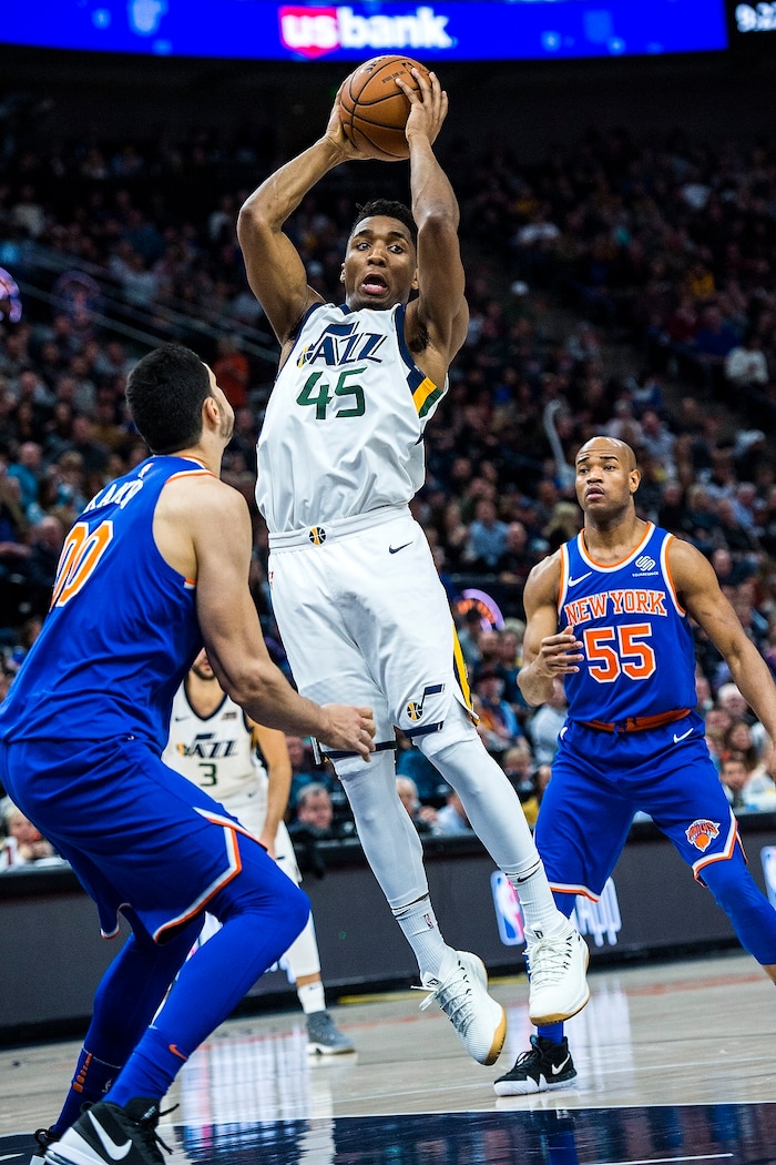 (Chris Detrick  |  The Salt Lake Tribune)  Utah Jazz guard Donovan Mitchell (45) passes around New York Knicks center Enes Kanter (00) and New York Knicks guard Jarrett Jack (55) during the game at Vivint Smart Home Arena Friday, January 19, 2018.  