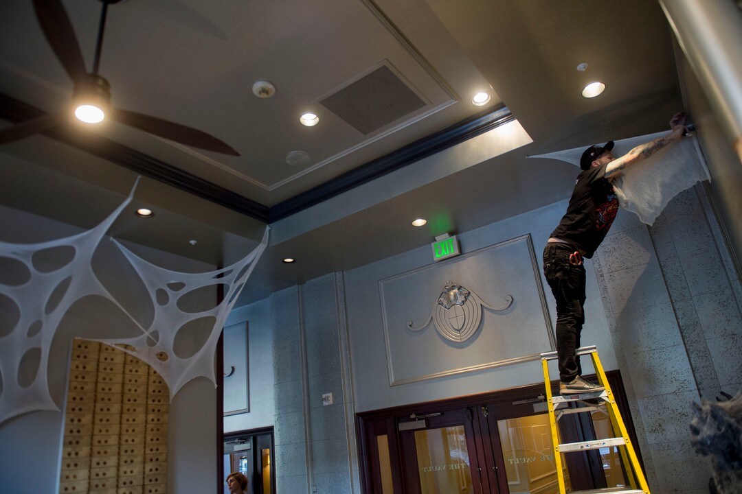 (Jeremy Harmon  |  The Salt Lake Tribune) Jimmy Dilley, Creative Director for Nightmare on 13th haunted house, puts up decorations at the Vault Bar at Hotel Monaco on Tuesday, Oct. 15, 2019. The downtown Salt Lake City bar has partnered with Nightmare on 13th to create a Halloween themed experience for bar patrons.